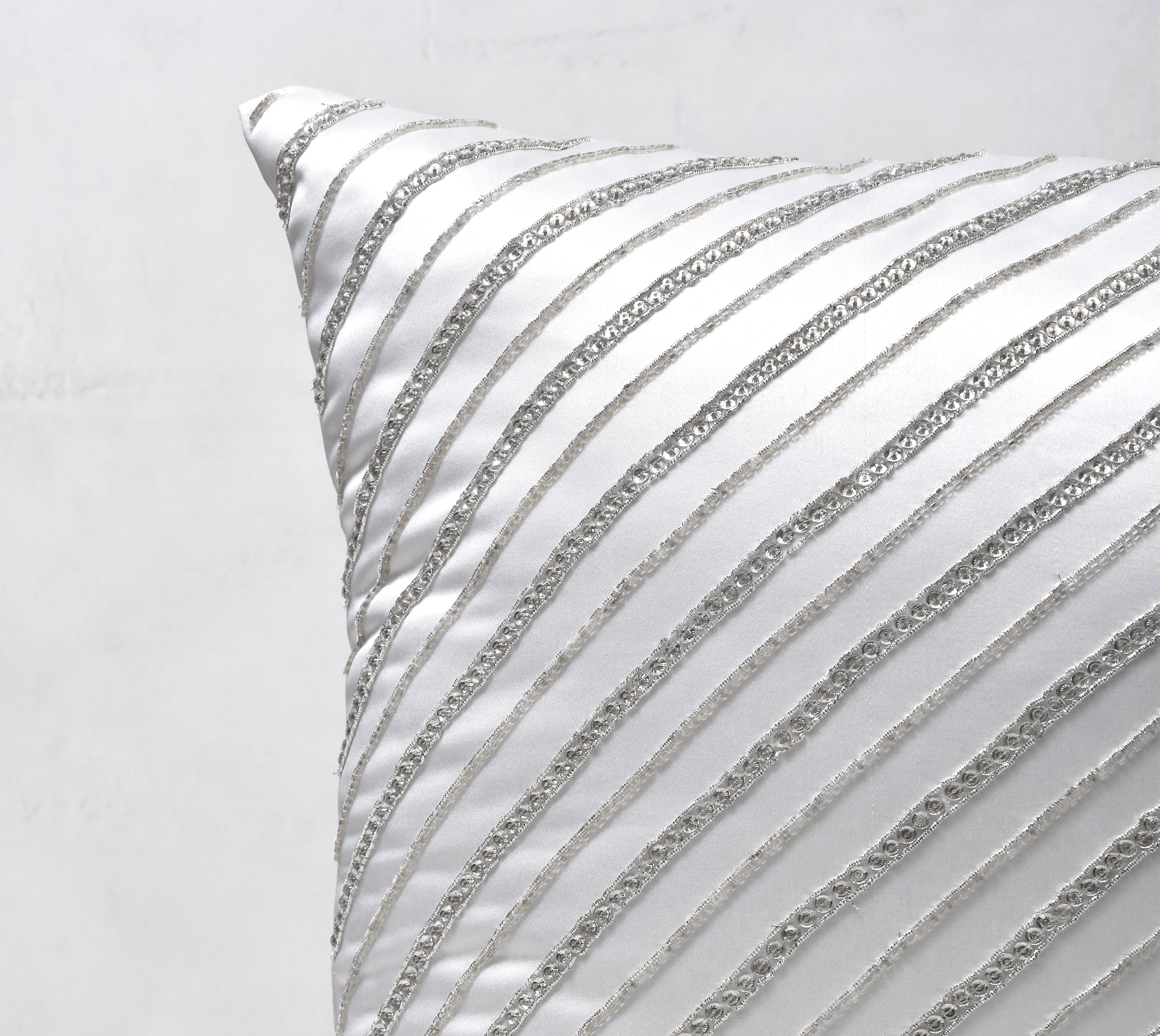 silver and white decorative pillows