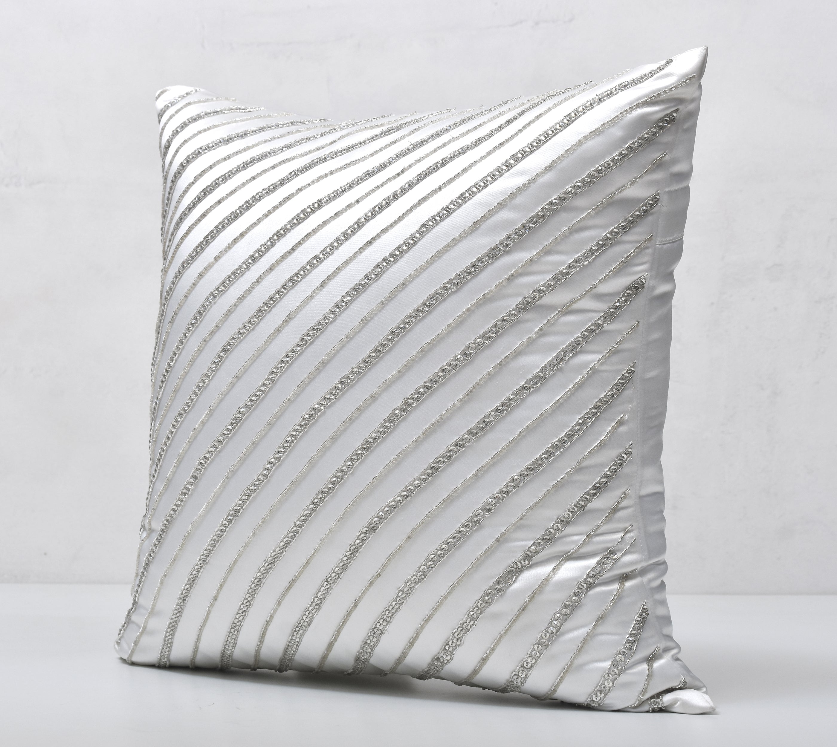 silver and white decorative pillows