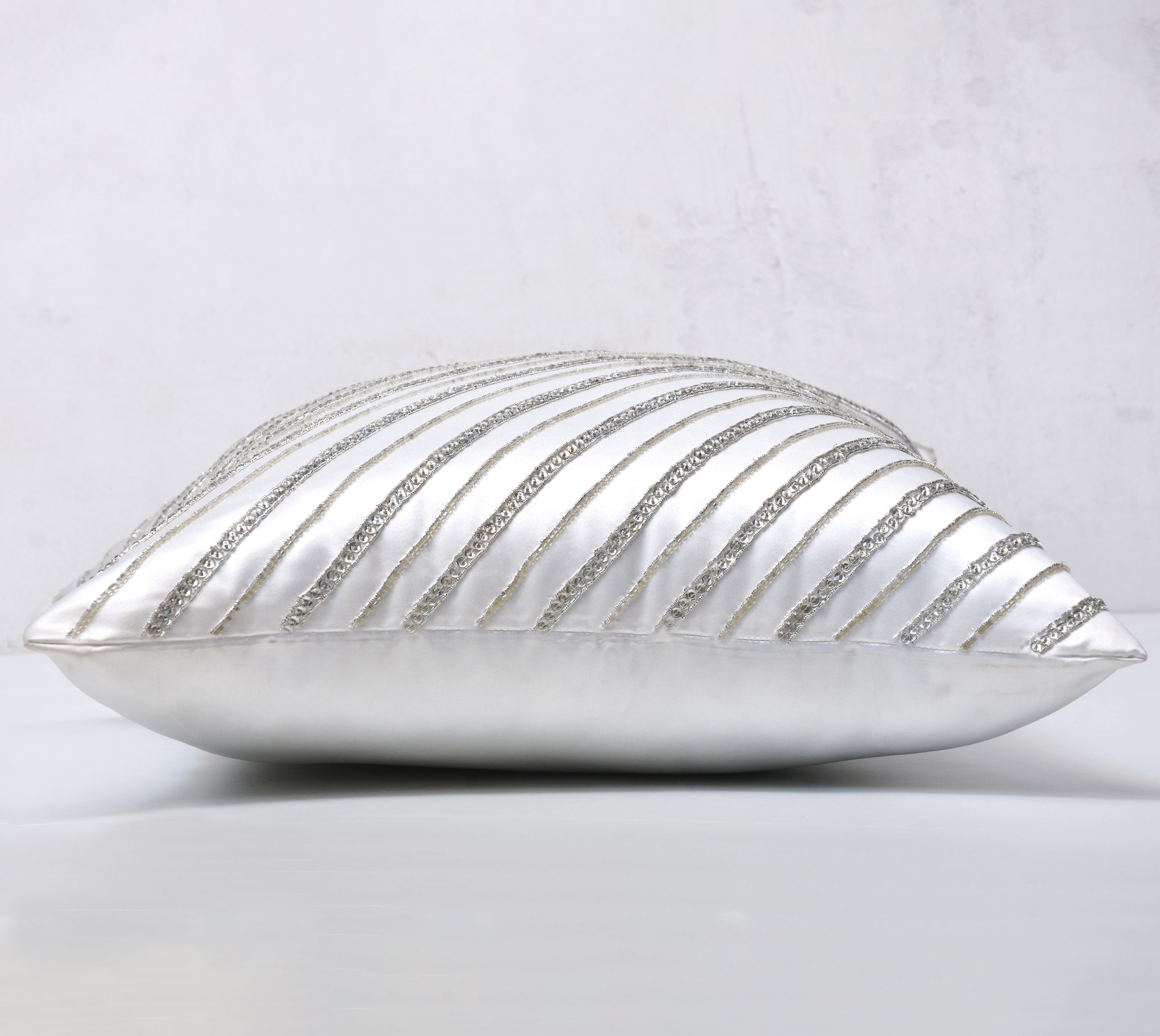 silver and white decorative pillows